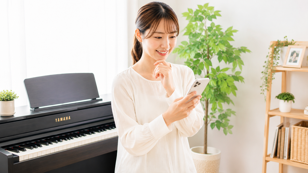 YAMAHA電子ピアノの買取や処分条件をスマホで確認する女性